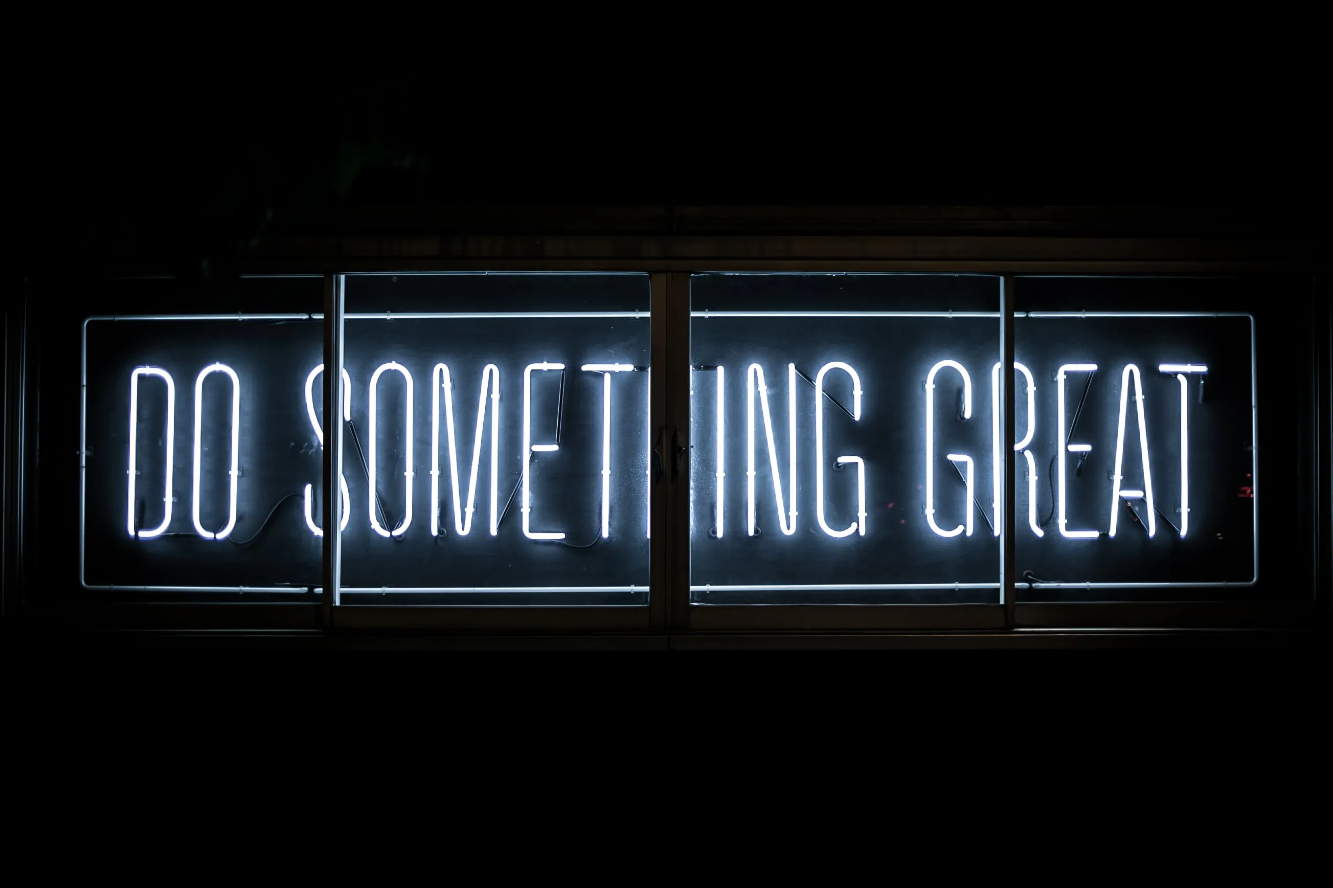 Neon sign displaying "Do something great"